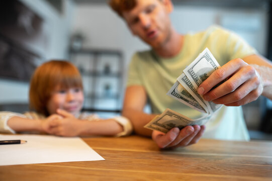 Dad Teaching His Little Son The Financial Basics