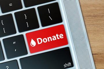 Donate button on computer keyboard. Donation and charity concept. 