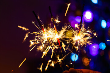 Burning sparklers in the dark. Bright sparks close-up. Christmas mood. - 544433181