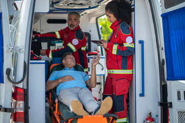 Ambulance staff listening to the sick man complaints