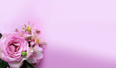Pink roses and alstroemeria on a light pink background. Delicate floral arrangement. Background for a greeting card.