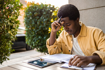 African American studying online outdoors