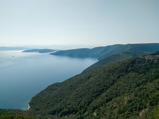Fototapeta na wymiar Mountainous coastline of island Cres covered with forest and pristine sea