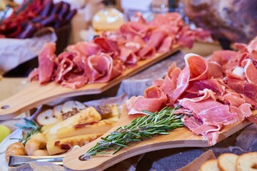 Sliced pieces of ham meat with spices. Food products for table decoration in a restaurant