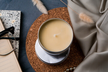 Soy candles in metal cans, handmade modern hobby , soy wax candles on cozy background.Massage candles.
