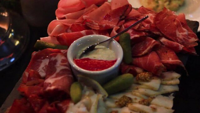 Square dish with sliced meat and sauce mixture in restaurant