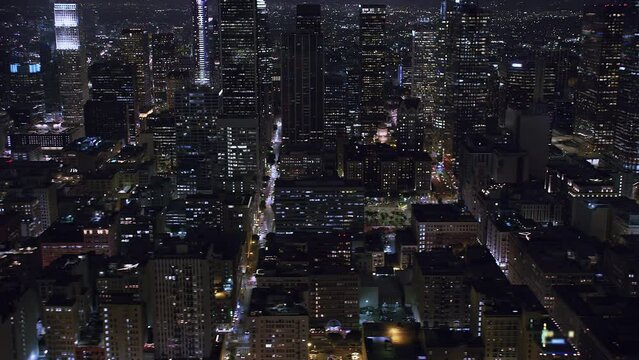 
Beautiful Shot of Big City Street next to Skyscrapers. Aerial view of Downtown Los Angeles at Night. Blurred brands and Logos. Shot on helicopter in 8K.