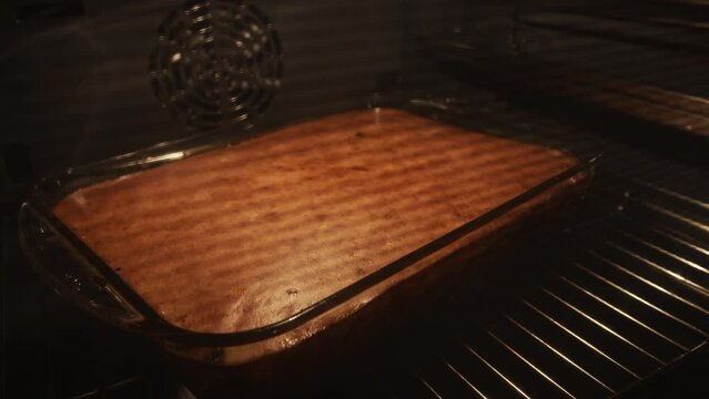 Closeup shot of Bulgarian moussaka baking in an oven. Timelapse.