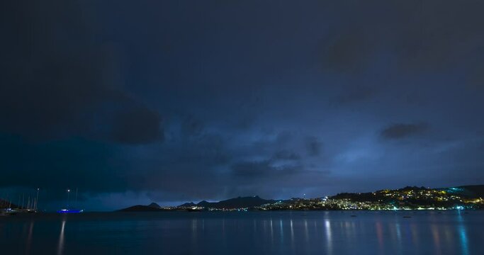 Timelapse of supercell storm approaching shore at night, lightnings, boats and beach Bitez, Bodrum