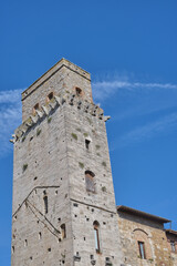 Fototapeta na wymiar A view of the towers in Piazza della Cisterna in San Gimignano, Tuscany, Italy