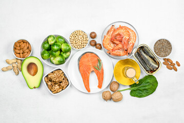 food sources of omega-3 and omega-6 on a light concrete background