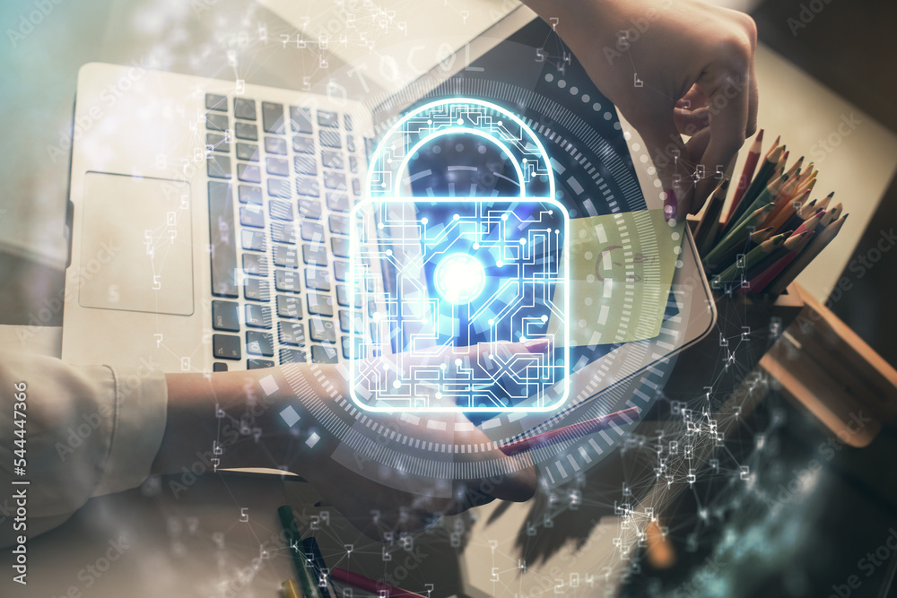 Poster double exposure of woman hands working on computer and lock hologram drawing. security concept.