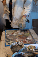 art workshop, messy objects, brushes, paint all mixed up disorganized, woman artist