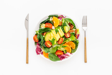 Healthy vegetarian lanch with bowl of green salad with avocado and tomatoes