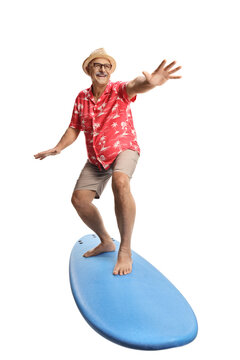Happy mature male tourist on top of a surfing board