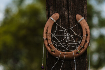 Old rusty horseshoe on a wooden background, rural concept, sunset light, Lucky Horseshoe, The concept of good luck in business. The symbol of well-being.