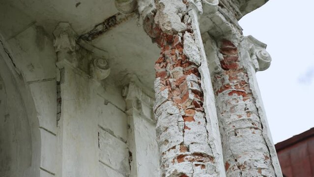 Ancient destroyed red brick columns of old abandoned building, close-up.