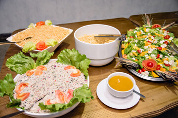 plates with salads served on top of a dining table