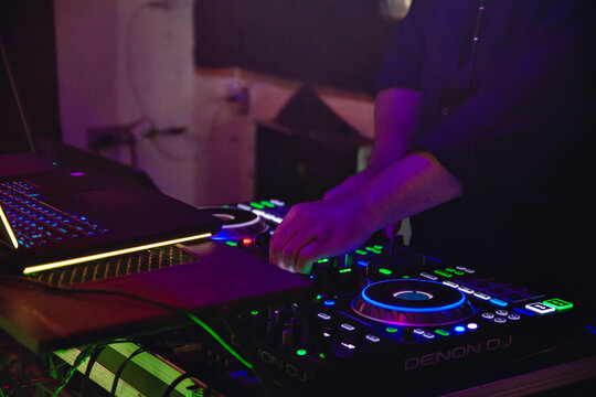 the hands of a dj mixing music on the cdj
