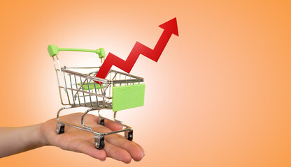 Miniature cart from supermarket. Inflation growth arrow. Consumer inflation. Rising food prices....