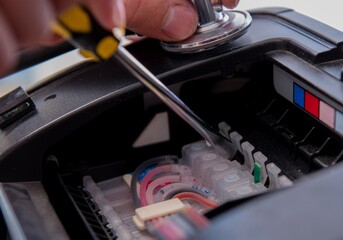 Repairman repairing broken color printer