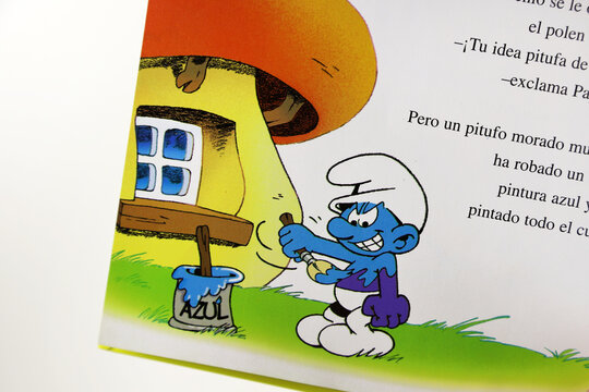  The Smurfs storybook. Characters created by Peyo. TV series. Book for children. Stories for children. Purple Smurf painting himself blue.