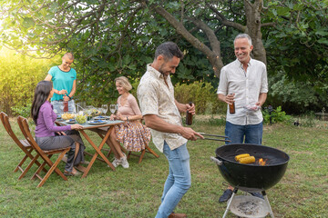 smiling happy and laughing together group of people around the barbecue. Joy concept.