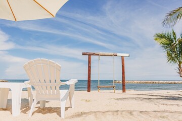 Beach bar cafe in white theme in bright sky and blue sea of tropical vacation.