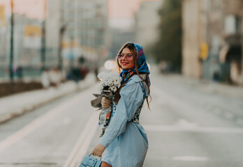 Fototapeta premium A modern woman walking the streets of the city dressed in modern clothes from the 19th century