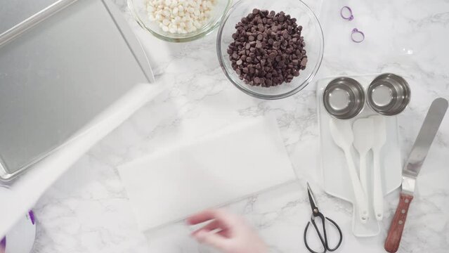 Flat lay. Step by step. Ingredients to prepare chocolate dipped strawberries on a marble surface.