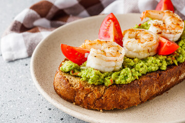 delicious Italian bruschetta with shrimps on a gray stone background
