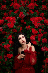 Vampire girl on a background of red roses