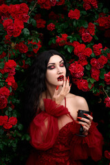 Vampire girl on a background of red roses