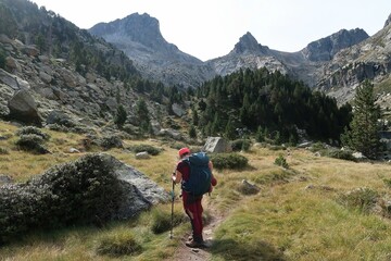Obraz premium Pyrenees, Carros de Foc hiking tour. A week long hike from hut to hut on a natural scenery with lakes, mountains and amazing flora and fauna.