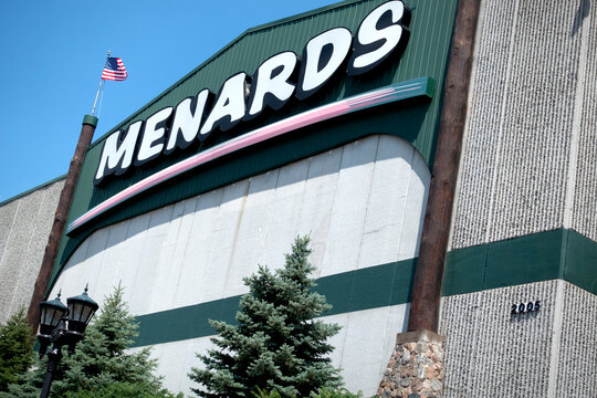 Menards Store for home improvement and building materials flying the American Flag with evergreens in the front patio. Blaine Minnesota MN USA