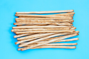 Bread sticks on blue background