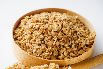 fresh raw buckwheat flakes on a white background