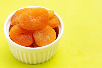 Dried apricots on green background.
