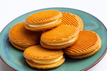 Custard cream sandwich biscuits on white background.