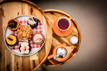tea and muffins on a round table 