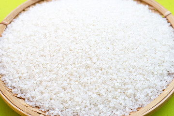 uncooked japan rice on green background