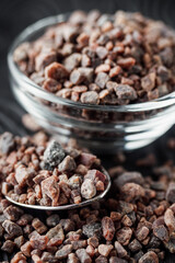 crystalline black Himalayan salt on a black wooden background