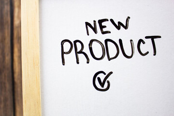 NEW PRODUCT - text concept with checkmark on white board. Business concept.
