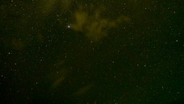 Time lapse of stars rotating over the ocean as high speed clouds move across the sky.