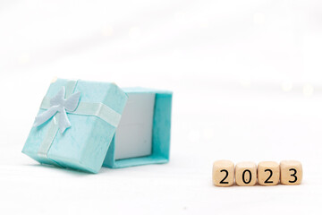 Decorative blue gift box on white background with bokeh of lights