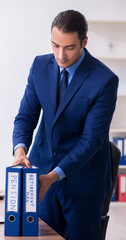 Young male accountant working in the office