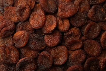 Tasty dried apricots as background, top view. Healthy snack