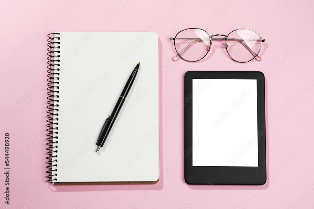 Poster E-book reader, notebook and glasses on pink background, flat lay. Space for text