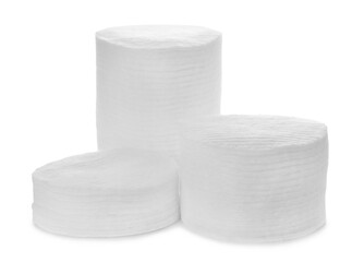 Stacks of cotton pads on white background