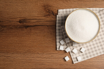 Granulated and refined sugar on wooden table, flat lay. Space for text